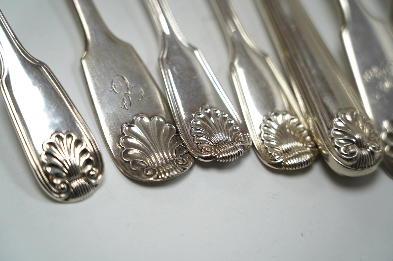 A pair of early Victorian Scottish silver tablespoons, John Pringle, Edinburgh, 1838, a silver fish knife, three assorted 19th century silver forks and a William IV silver fiddle, thread and shell pattern sauce ladle, 13